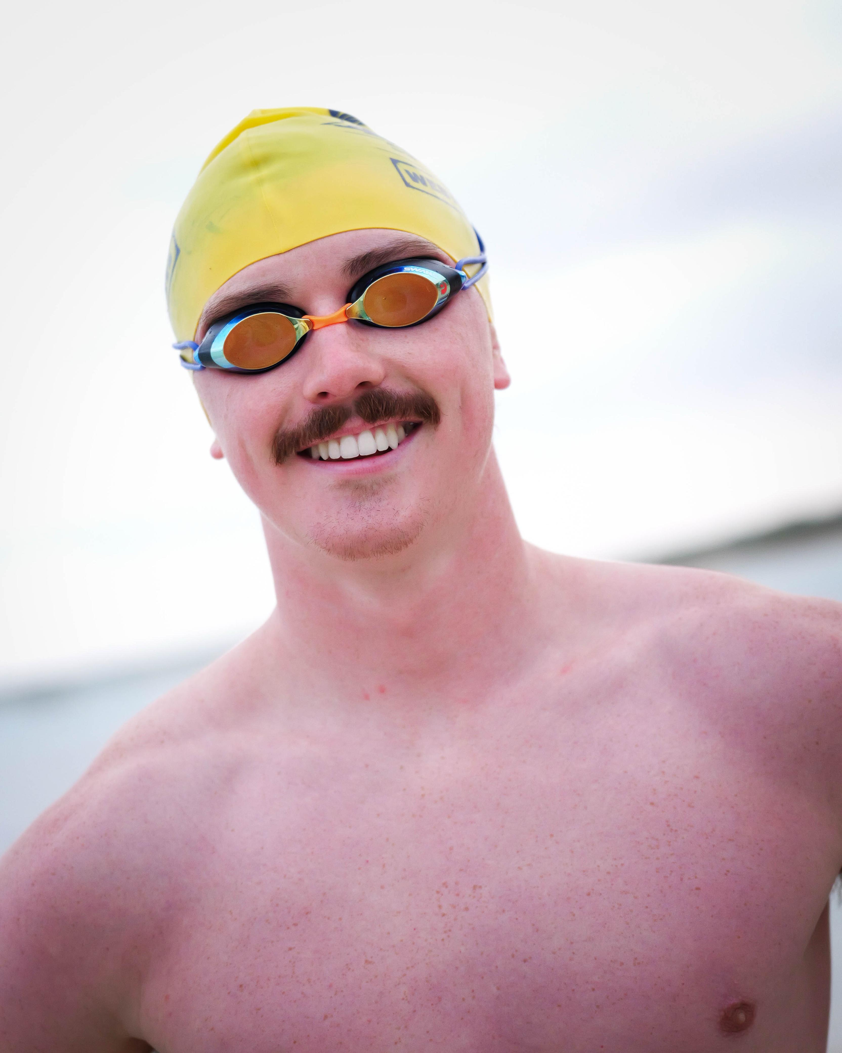 Olympian Finn McGeever wearing a yellow swim cap and SWANS SRX goggles 